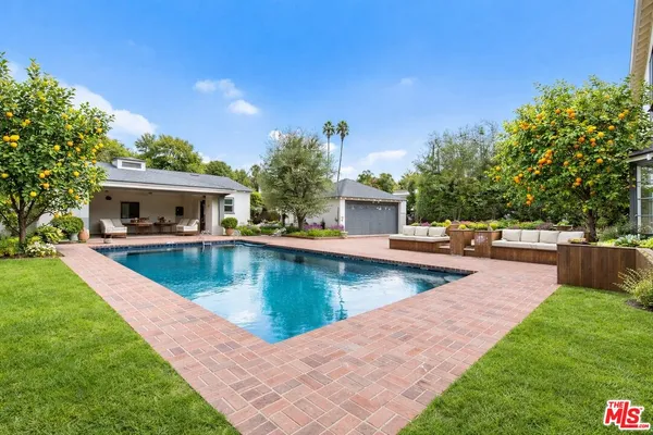 a view of a house with swimming pool and a yard