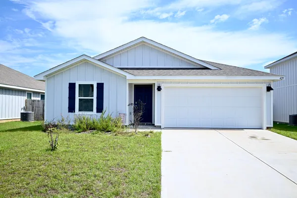 a front view of house with yard and green space