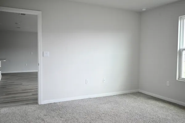 an empty room with closet area