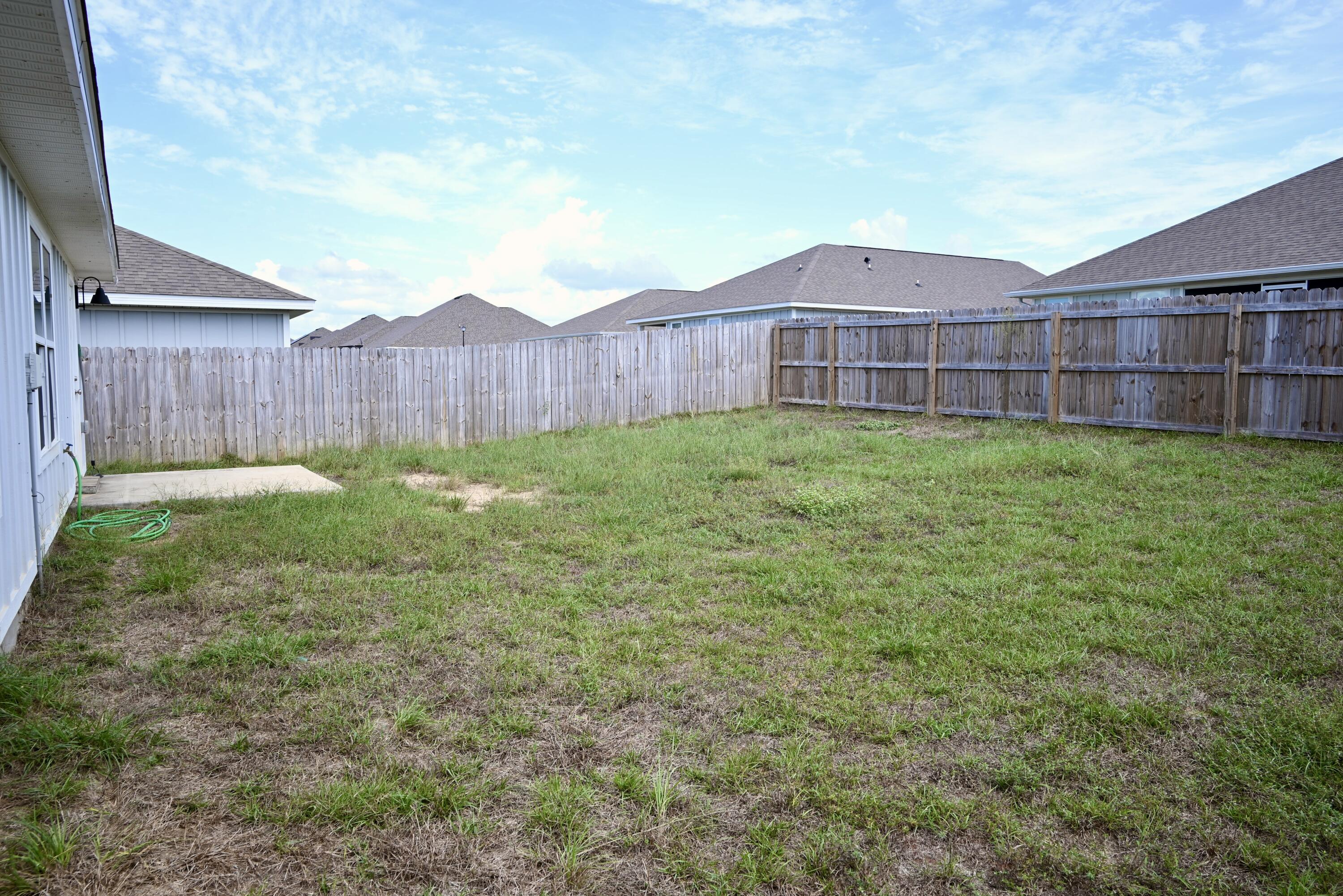 429 Scarborough Street Crestview, FL 32539 - Photo 29 of 30 a view of a backyard with potted plants and wooden fence