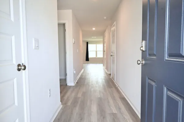 a view of a hallway with wooden floor