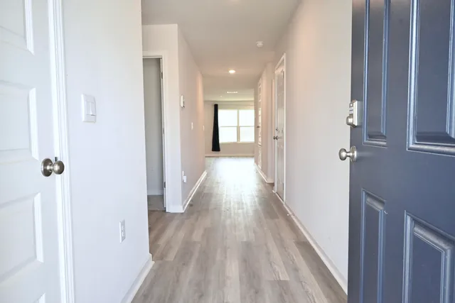 a view of a hallway with wooden floor