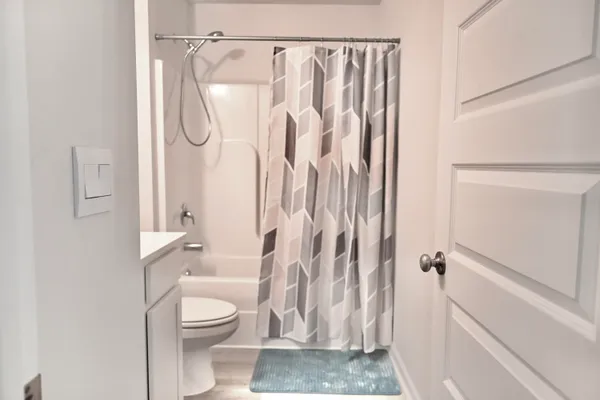 a bathroom with a shower a toilet and a shower