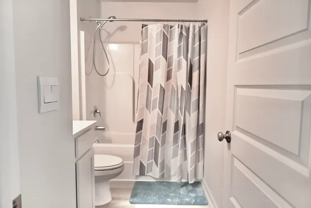 a bathroom with a shower a toilet and a shower