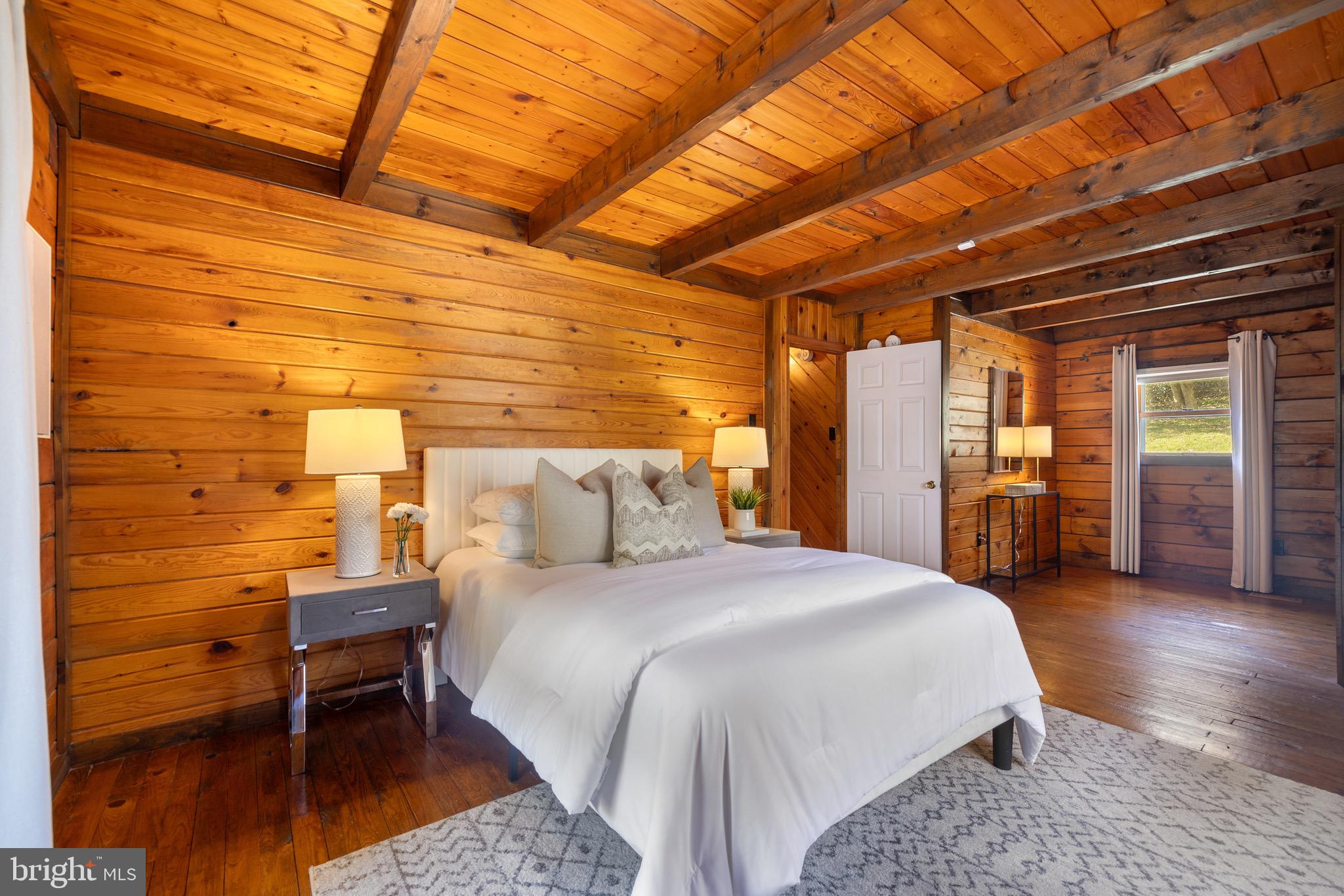 6402 Otis Street Cheverly, MD 20785 - Photo 19 of 52 a spacious bedroom with a bed and a table