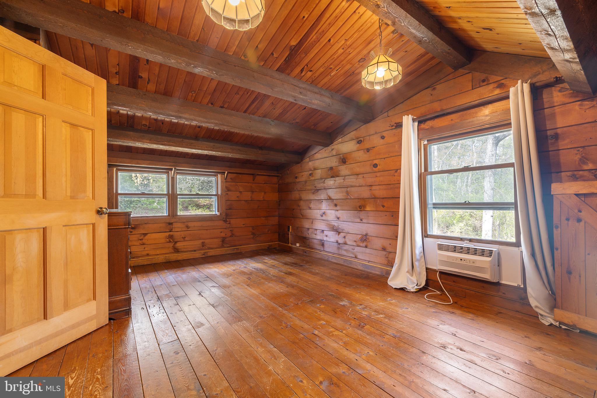 6402 Otis Street Cheverly, MD 20785 - Photo 25 of 52 an empty room with wooden floor and windows