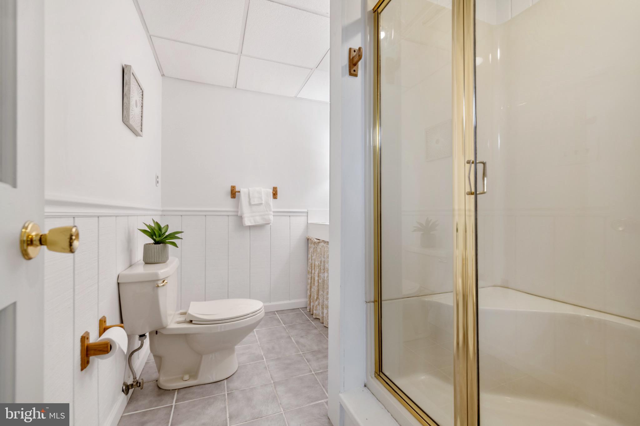 6402 Otis Street Cheverly, MD 20785 - Photo 36 of 52 a white toilet sitting next to a bathroom sink