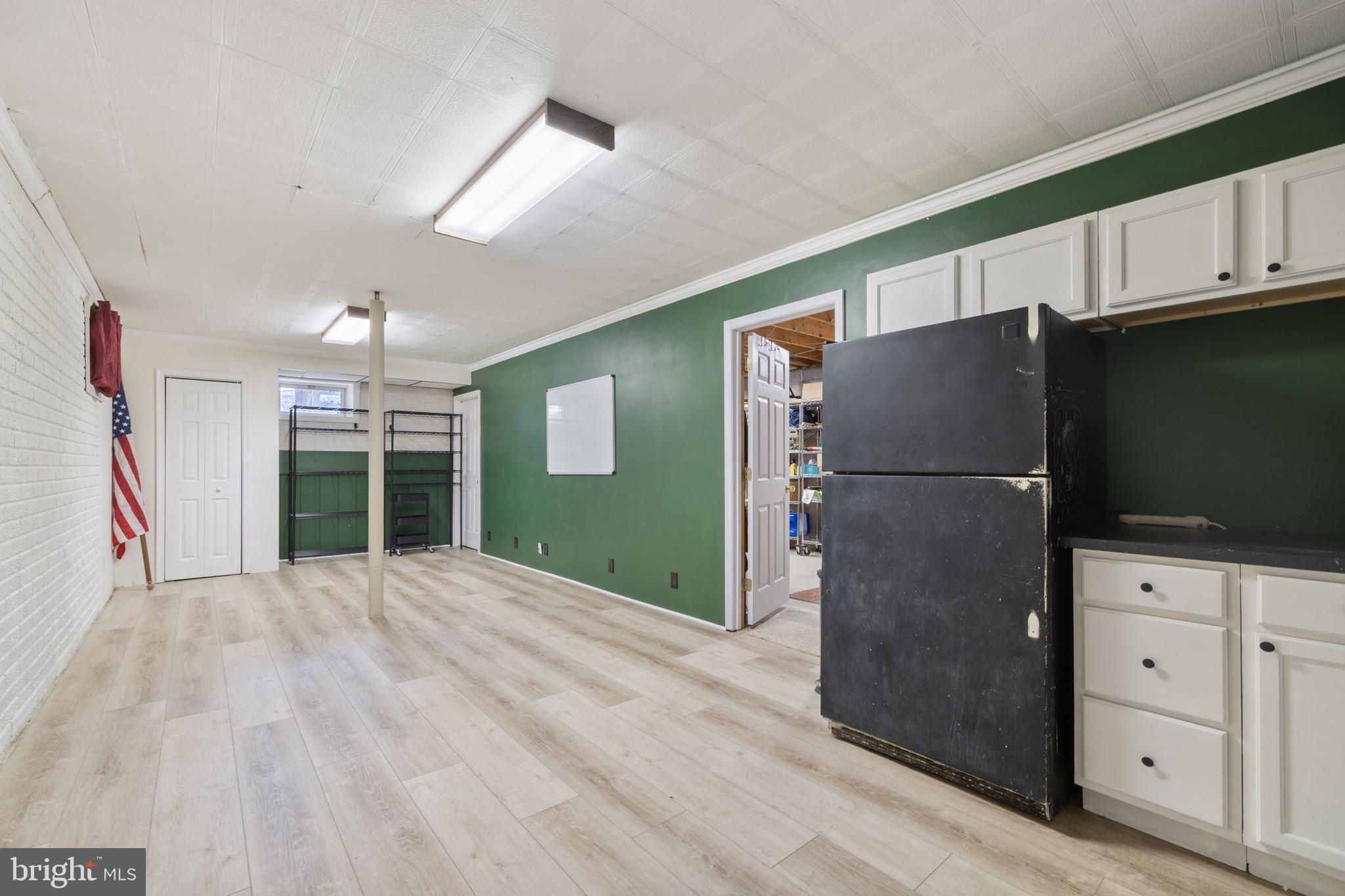 6402 Otis Street Cheverly, MD 20785 - Photo 38 of 52 a kitchen with stainless steel appliances a refrigerator and a fireplace