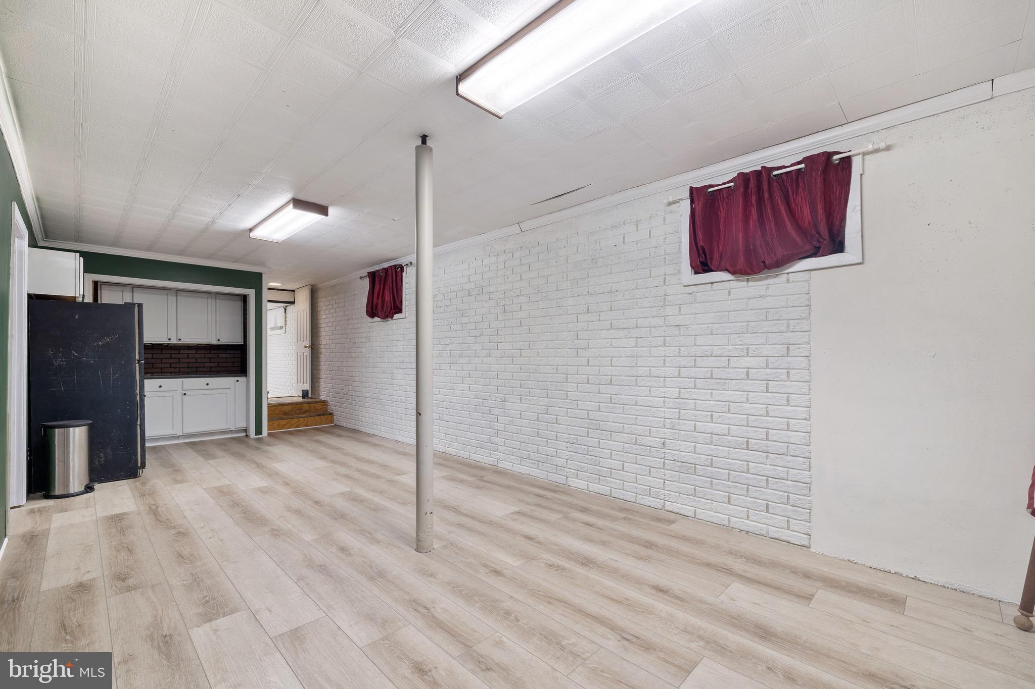 6402 Otis Street Cheverly, MD 20785 - Photo 40 of 52 a view of a hallway with a refrigerator and a stove