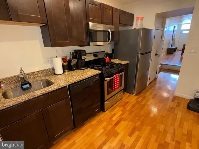 a kitchen with refrigerator and cabinets