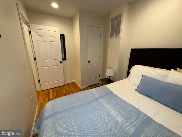 a bedroom with a bed and a mirror