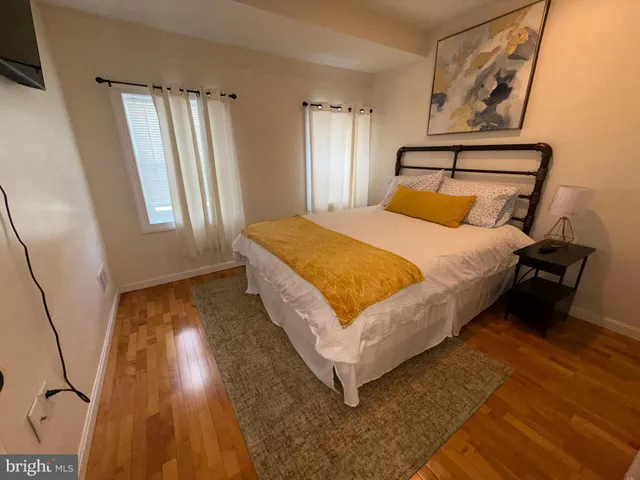 a bed sitting in a bedroom next to a window