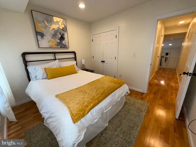 a bedroom with a bed and a painting on the wall