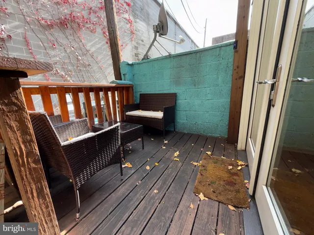 a view of a balcony with wooden floor