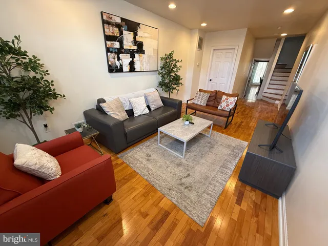 a living room with furniture and a potted plant