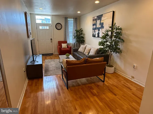a living room with furniture and a potted plant