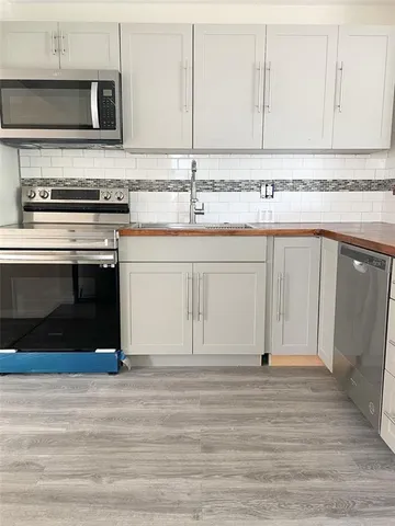 a kitchen with stainless steel appliances granite countertop a stove and a sink