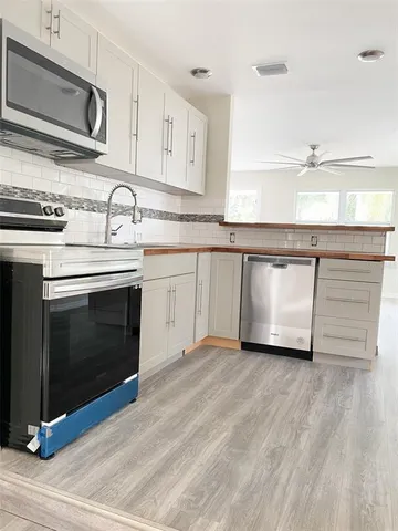 a kitchen with stainless steel appliances granite countertop a stove and a sink
