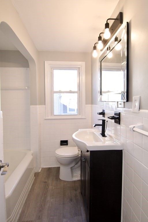 71 Mayflower Road Springfield, MA 01118 - Photo 24 of 42 a bathroom with a sink toilet a mirror and tub