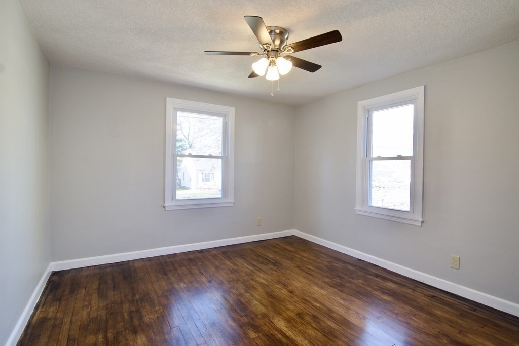 71 Mayflower Road Springfield, MA 01118 - Photo 25 of 42 a view of an empty room with wooden floor and a window