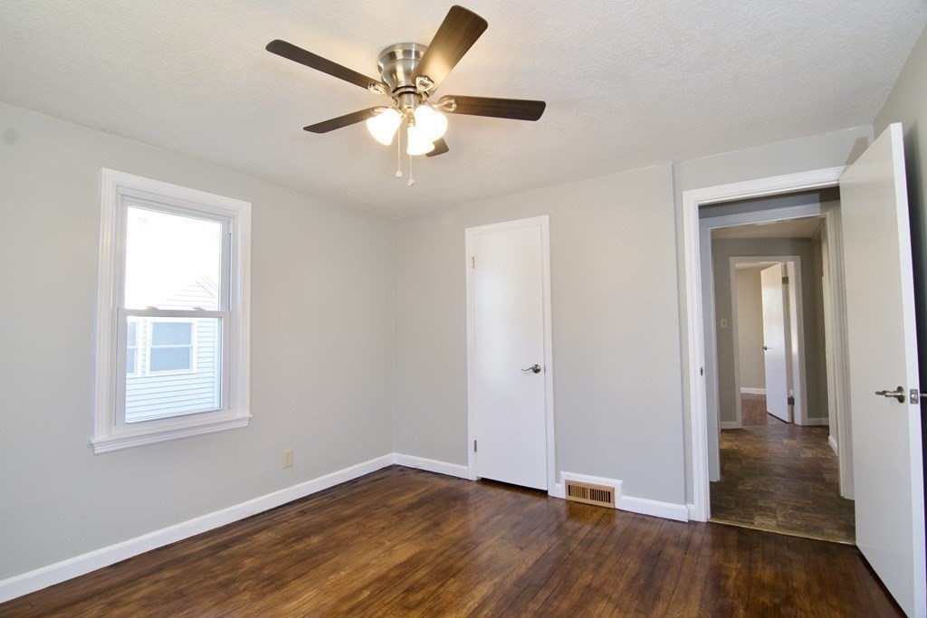 71 Mayflower Road Springfield, MA 01118 - Photo 26 of 42 an empty room with wooden floor and windows