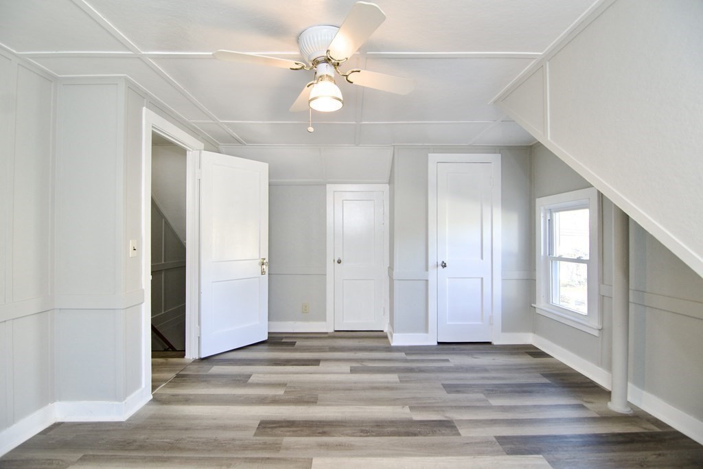 71 Mayflower Road Springfield, MA 01118 - Photo 32 of 42 an empty room with wooden floor and ceiling fan