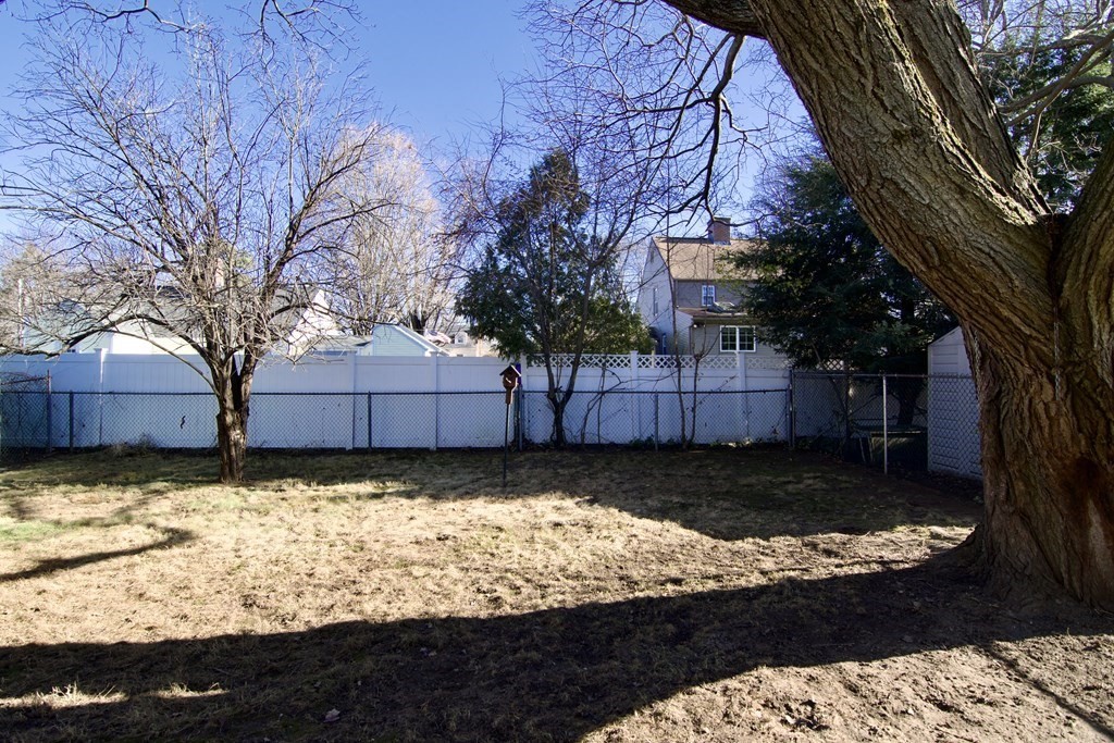 71 Mayflower Road Springfield, MA 01118 - Photo 4 of 42 a view of a yard with wooden fence