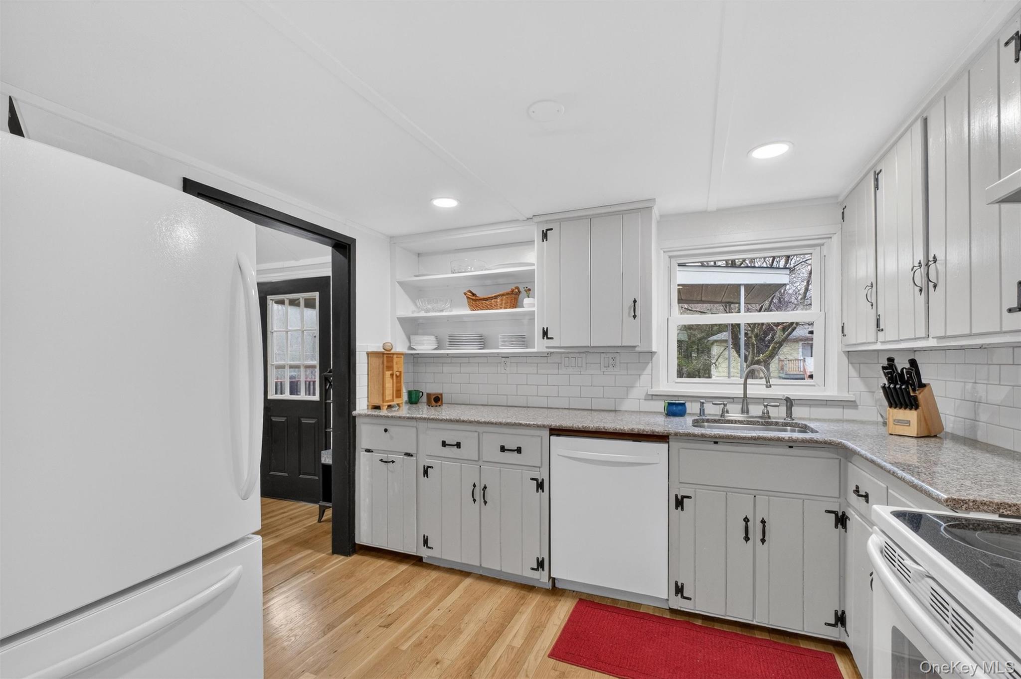 3 Camden Road Brewster, NY 10509 - Photo 16 of 39 a kitchen with granite countertop white cabinets and white appliances