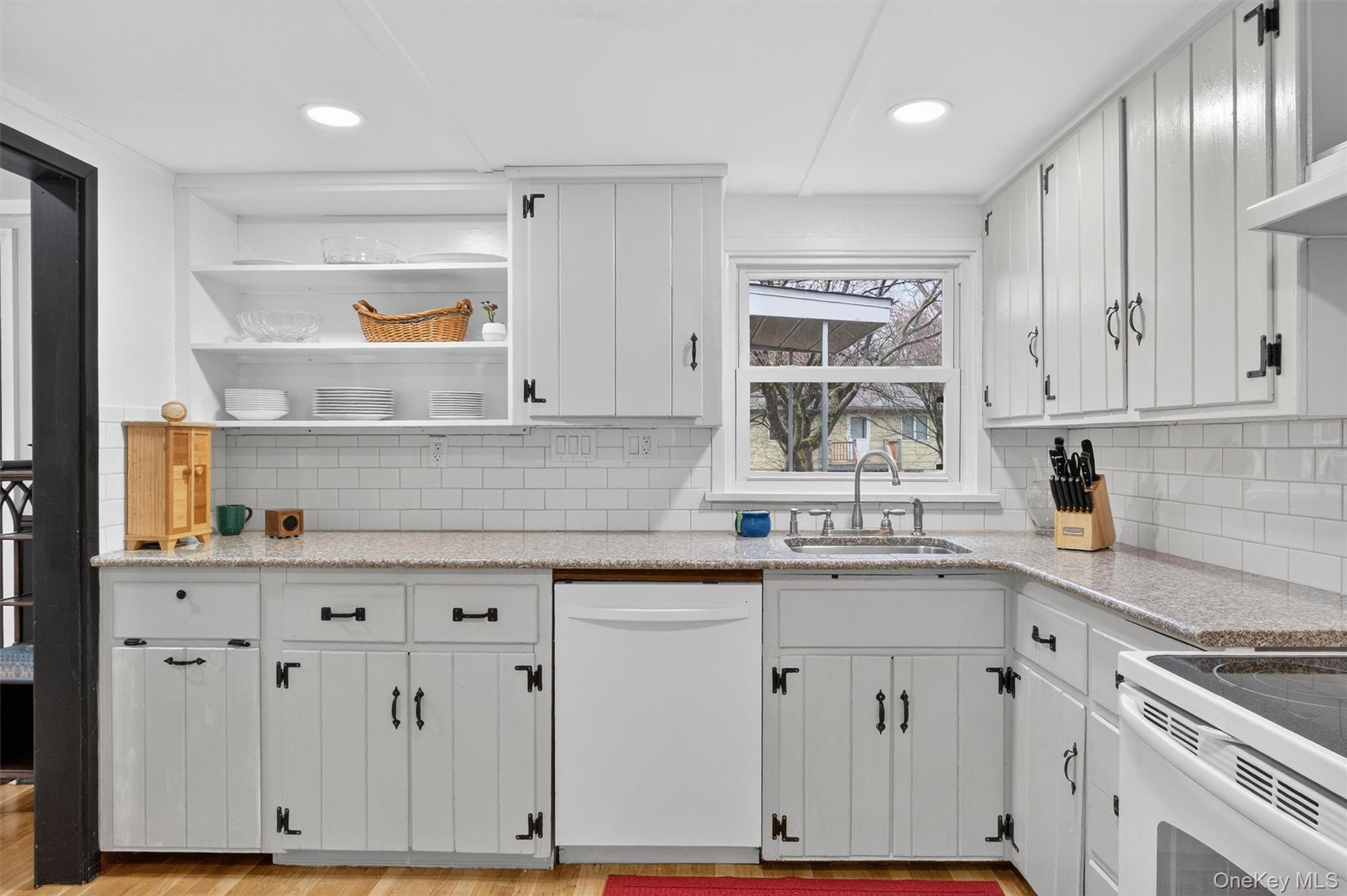 3 Camden Road Brewster, NY 10509 - Photo 18 of 39 a kitchen with stainless steel appliances granite countertop a sink and cabinets with wooden floor