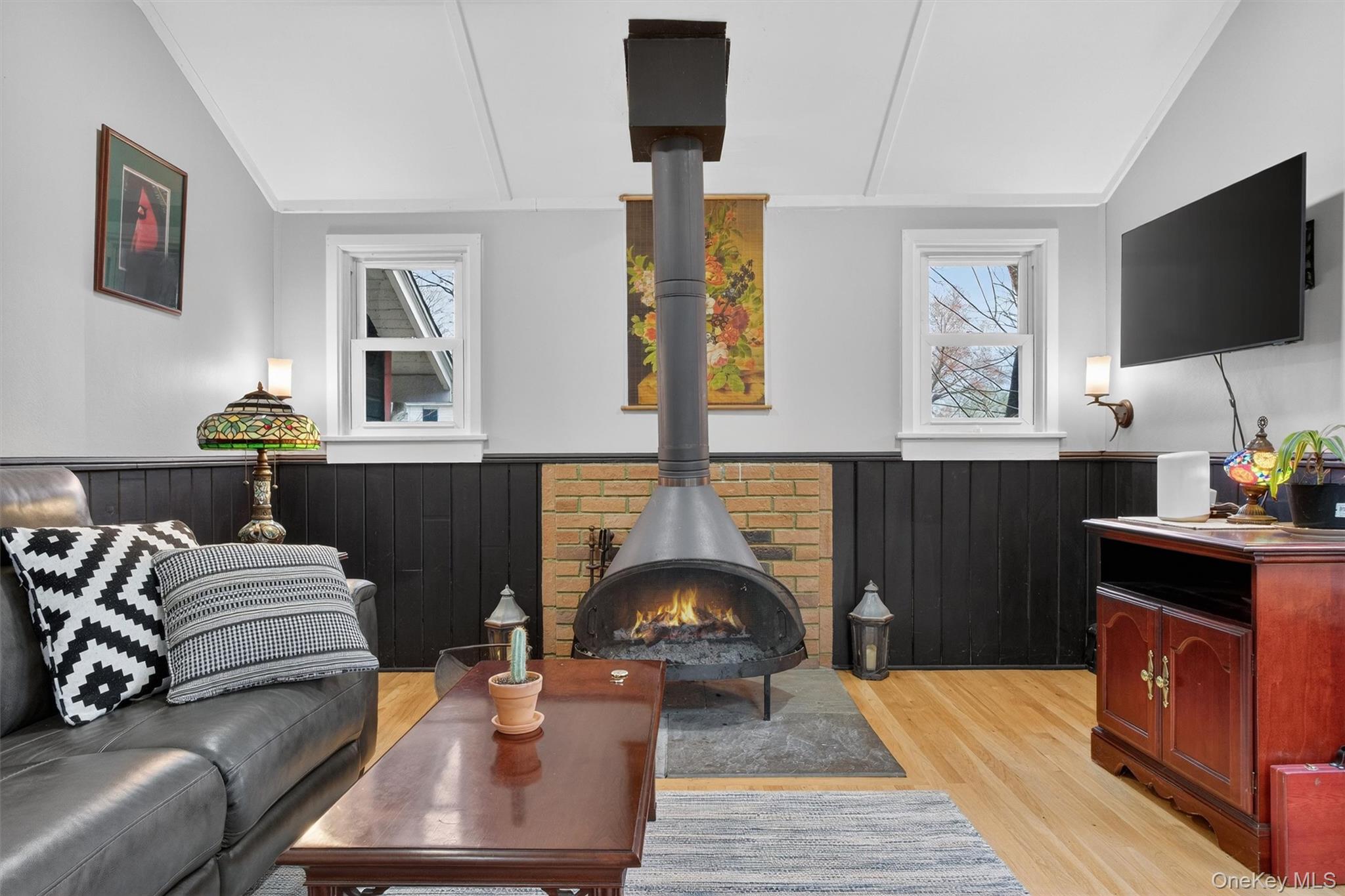 3 Camden Road Brewster, NY 10509 - Photo 10 of 39 a living room with furniture a flat screen tv and a fireplace