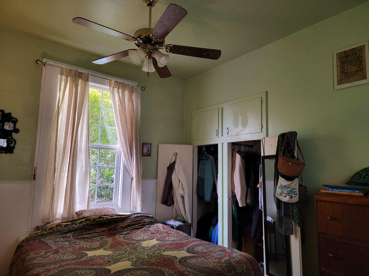 120 13th Street Arcata, CA 95521 - Photo 30 of 37 a bedroom with a bed a window and a chandelier