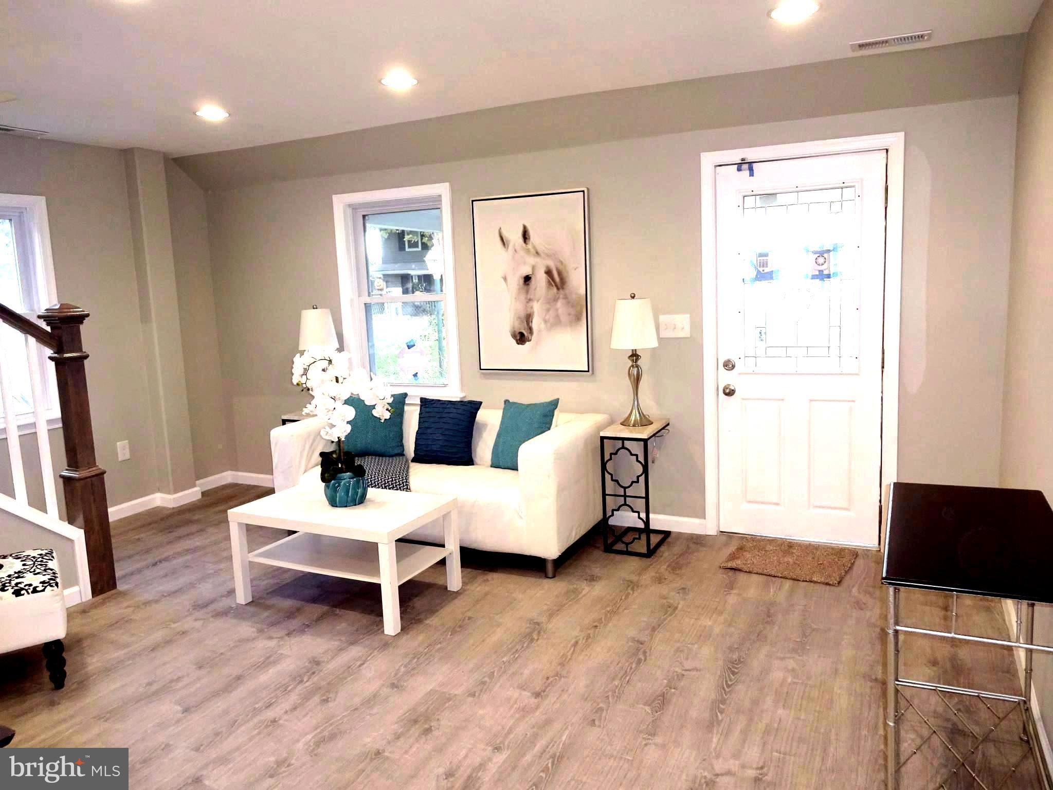 7800 Fairgreen Road Baltimore, MD 21222 - Photo 2 of 24 Living Room w/ New Flooring and Cam Lighting