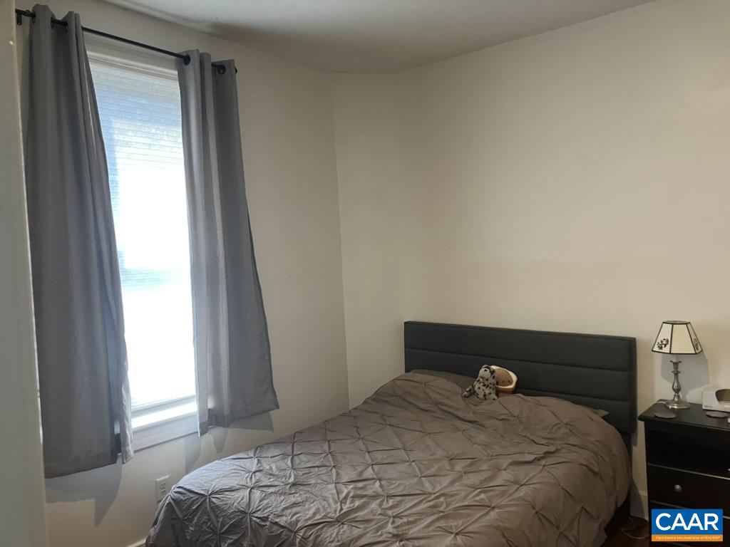 711 West Main Street, Unit B Charlottesville, VA 22903 - Photo 5 of 7 a bedroom with a bed and a window