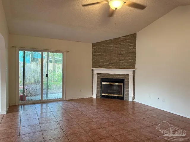 wooden floor fireplace and natural light in room