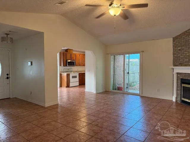 wooden floor in an empty room with a fireplace