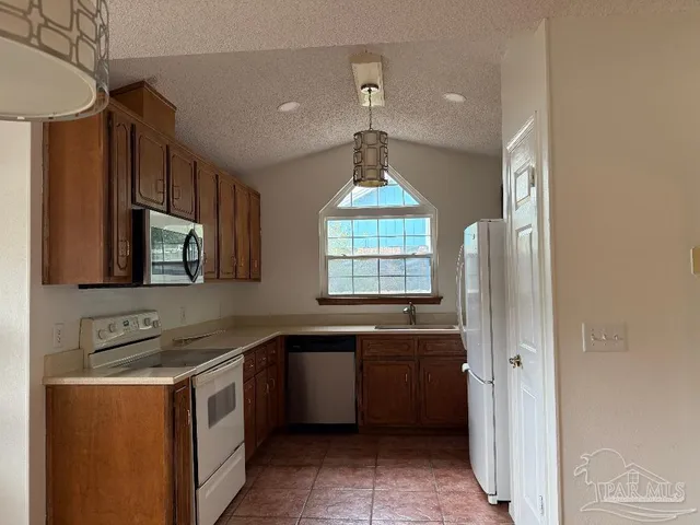 a kitchen with a sink stove and microwave