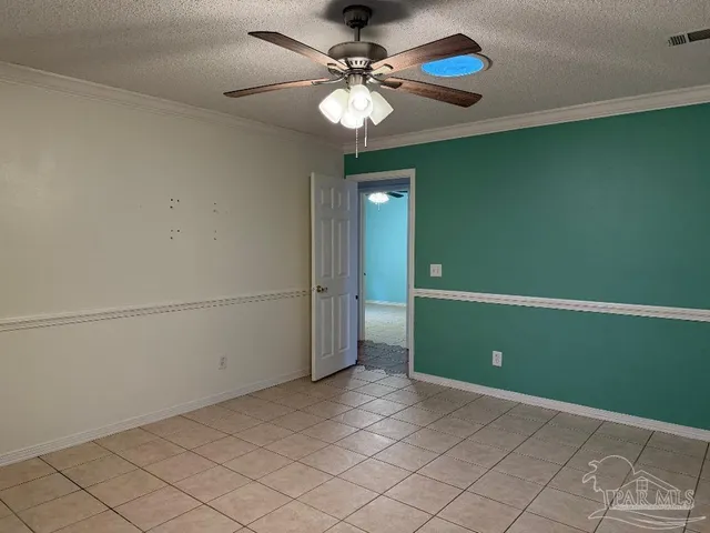 a view of a room that has a fan and a chandelier fan