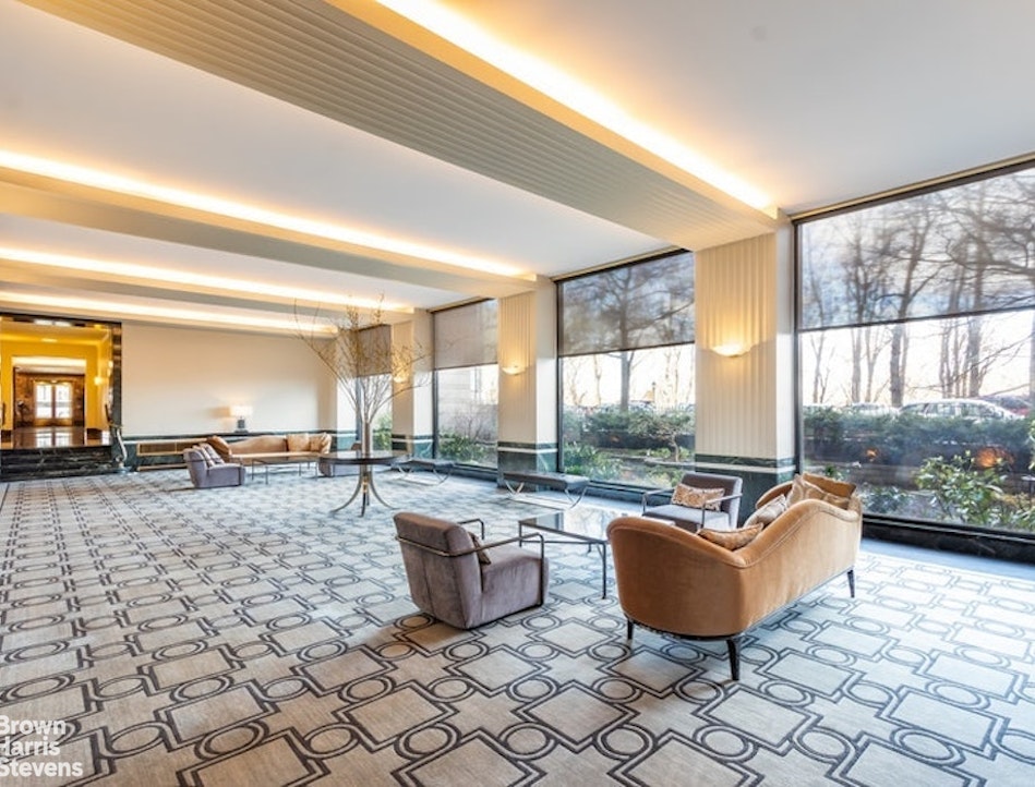 140 Riverside Drive, Unit 5K Manhattan, NY 10024 - Photo 14 of 16 a living room with furniture and a floor to ceiling window