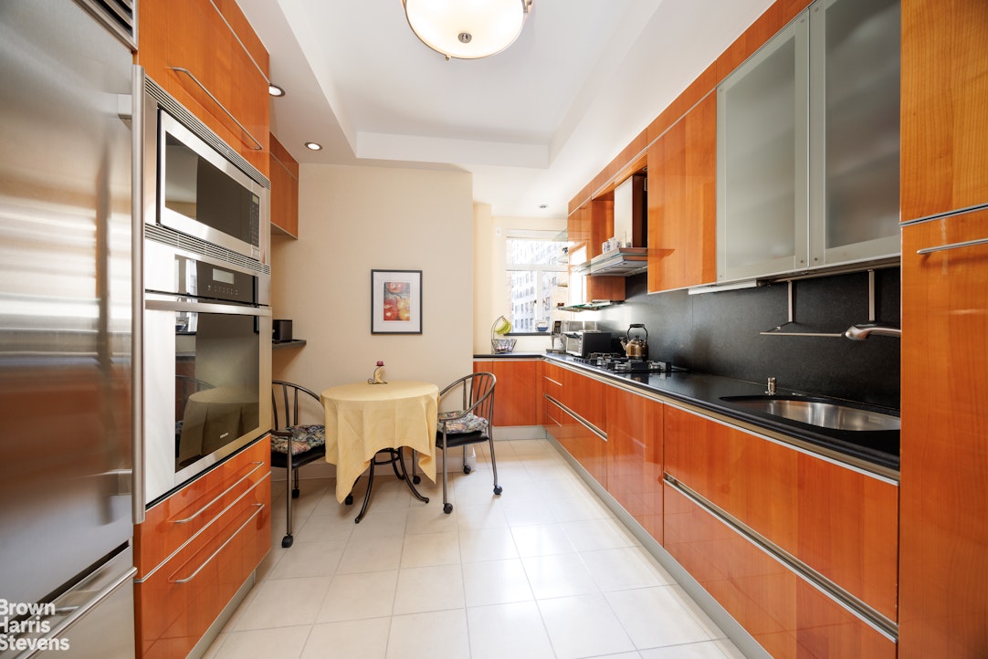 140 Riverside Drive, Unit 5K Manhattan, NY 10024 - Photo 3 of 16 a kitchen with stainless steel appliances kitchen island granite countertop a sink and cabinets