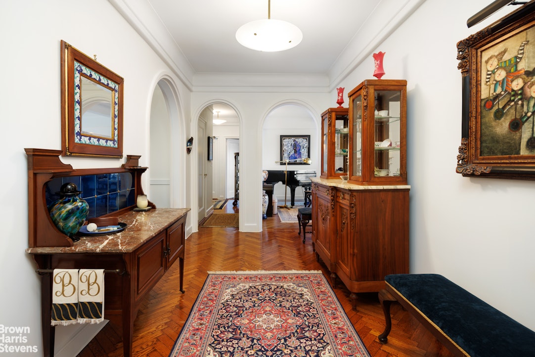 140 Riverside Drive, Unit 5K Manhattan, NY 10024 - Photo 4 of 16 a view of a hallway with wooden floor and furniture