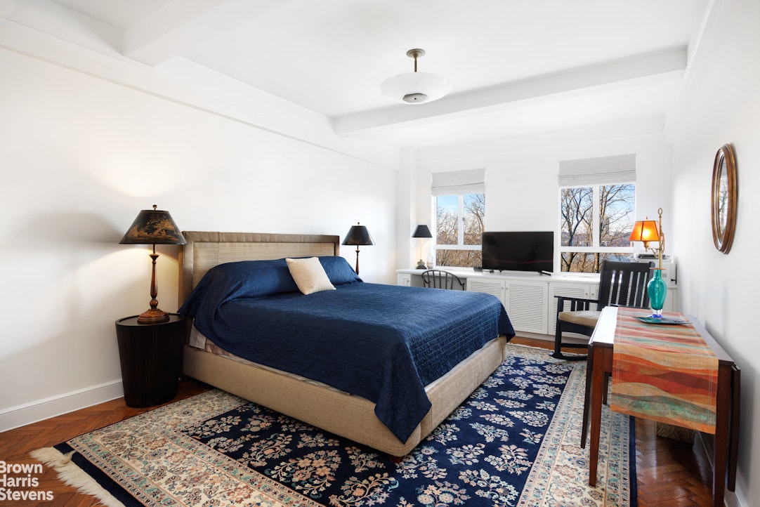 140 Riverside Drive, Unit 5K Manhattan, NY 10024 - Photo 6 of 16 a bedroom with a bed and wooden floor