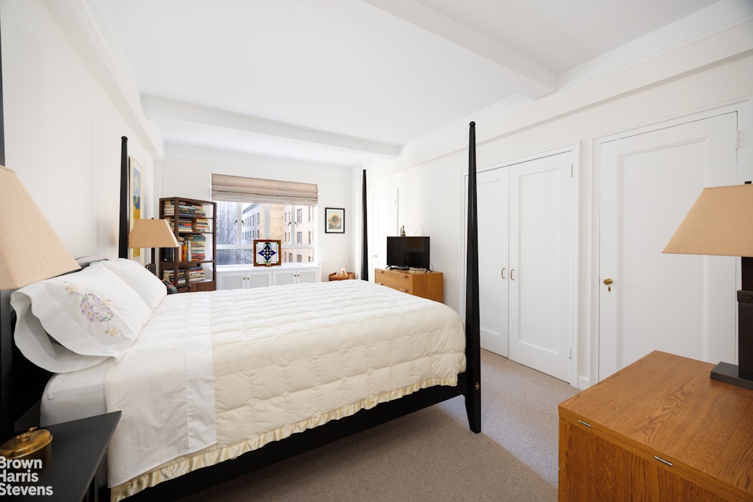 140 Riverside Drive, Unit 5K Manhattan, NY 10024 - Photo 7 of 16 a bedroom with a bed and a lamp