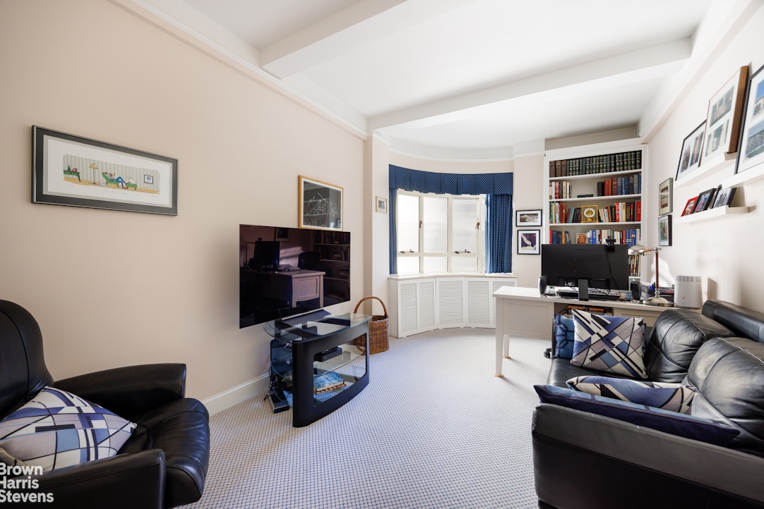 140 Riverside Drive, Unit 5K Manhattan, NY 10024 - Photo 8 of 16 a living room with furniture and a flat screen tv