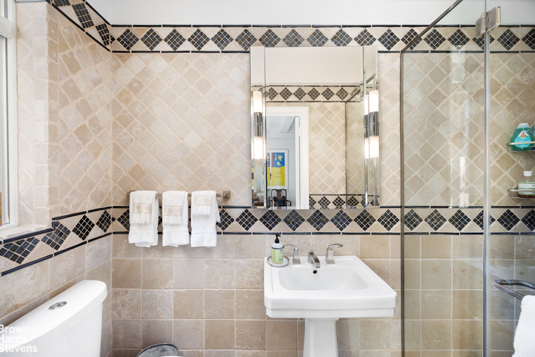 140 Riverside Drive, Unit 5K Manhattan, NY 10024 - Photo 9 of 16 a bathroom with a sink and a mirror