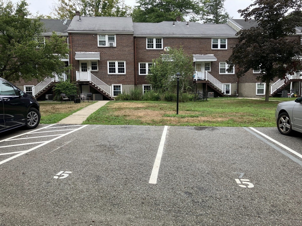 5 Linden Street, Unit 5 Wellesley, MA 02482 - Photo 1 of 1 a view of a house with a yard and large trees
