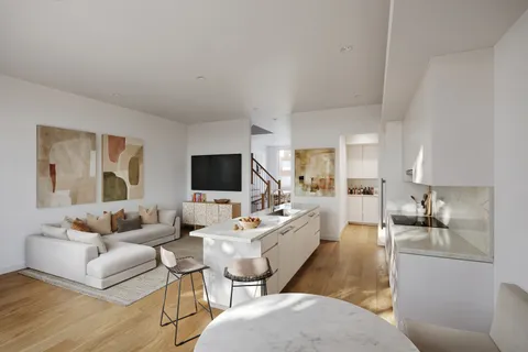 a living room with furniture wooden floor and a flat screen tv