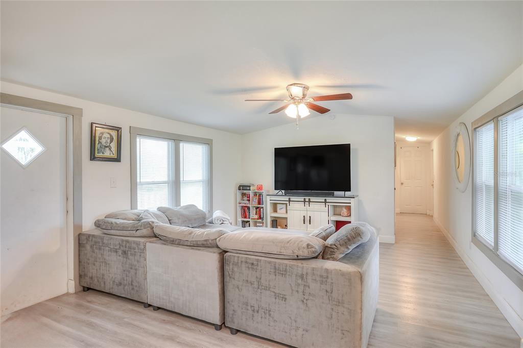 12552 Farmettes Road Lakeland, FL 33809 - Photo 12 of 43 a living room with furniture and a flat screen tv