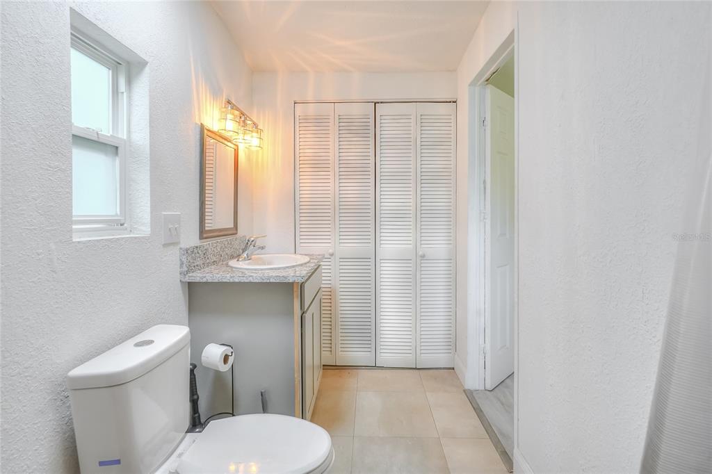 12552 Farmettes Road Lakeland, FL 33809 - Photo 16 of 43 a bathroom with a sink a toilet and shower