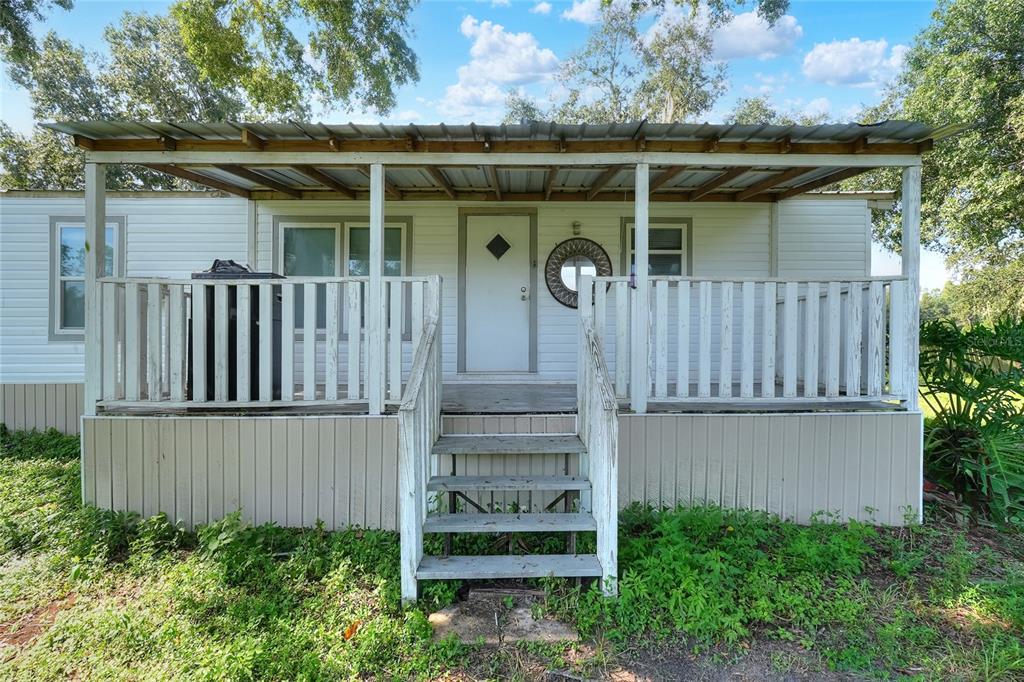 12552 Farmettes Road Lakeland, FL 33809 - Photo 30 of 43 a front view of a house with a garden