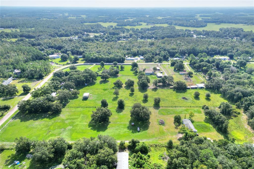 12552 Farmettes Road Lakeland, FL 33809 - Photo 40 of 43 an aerial view of residential houses with outdoor space and trees
